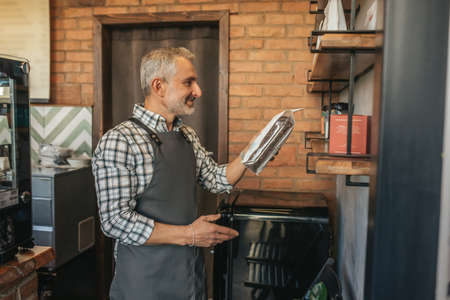 Man looking with pleasure at coffee packaging