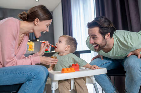 Young family having breakfast in the kitchenの写真素材