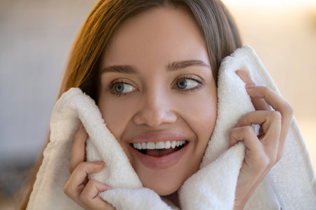 Close-up face of joyful woman looking awayの写真素材
