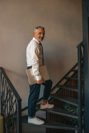 Man climbing stairs turning head to camera