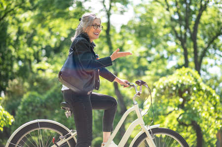 A woman enjoying a bike ride in the park