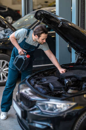 Technician in the care service changing engine oilの写真素材