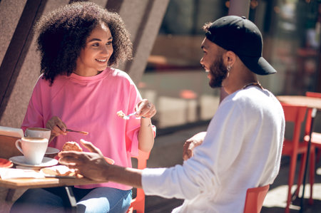 Cute young couple having coffee in the cafe