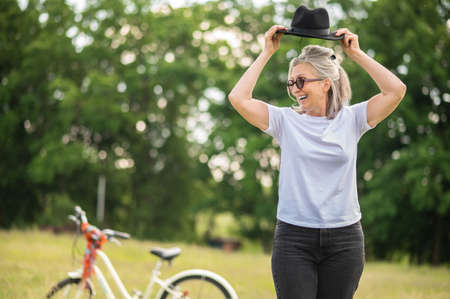 A happy woman spending time in the park and looking excitedの写真素材
