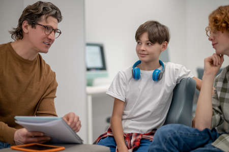 Schoolchildren and their teacher working together on a project