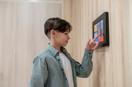 A boy touching screen of a sensor panelの写真素材