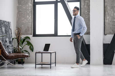 Business man in glasses walking in officeの写真素材