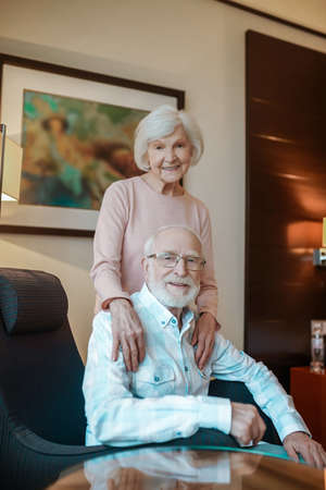 Elderly couple in a nice room looking happy and peacefulの写真素材