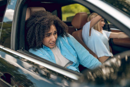 Girls in the car having car accident and looking scaredの写真素材