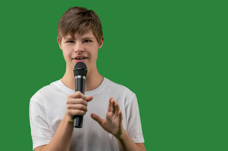 Young singer posing for the camera during the song performanceの写真素材