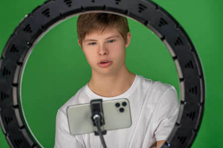 Teenager taking a selfie using a ring light