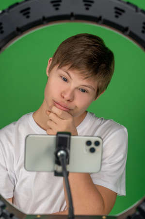 Modern boy taking selfies with a ring lightの写真素材