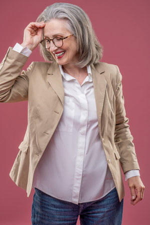 Effective mature woman in beige jacketの写真素材