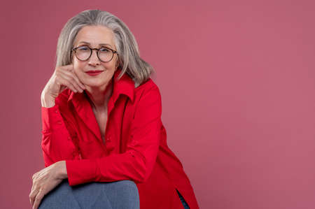 Picture of a woman in red on a pink background