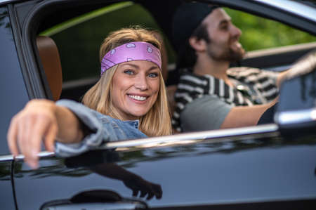 A couple in the car looking happy and cheerful