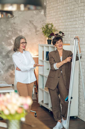 Two businesswomen in the office working on the projectの写真素材