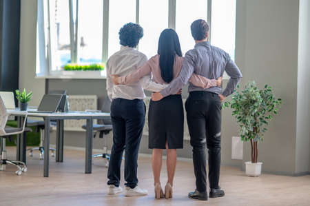 Young business colleagues looking happy and cheerful in the officeの写真素材