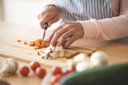 Close up of woman cutting vegetablesの写真素材