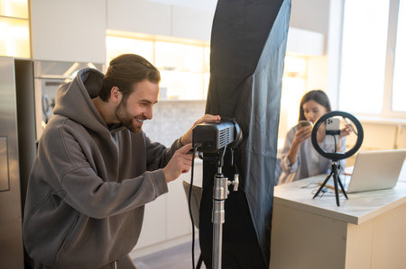 Cameraman and a video blogger preparing for shooting a vlog