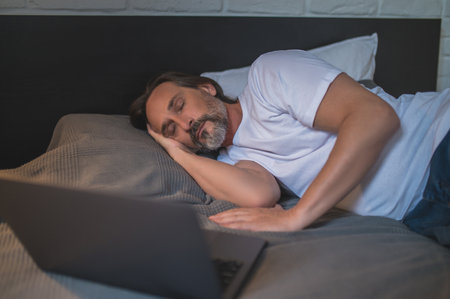 Man napping while watching movie online