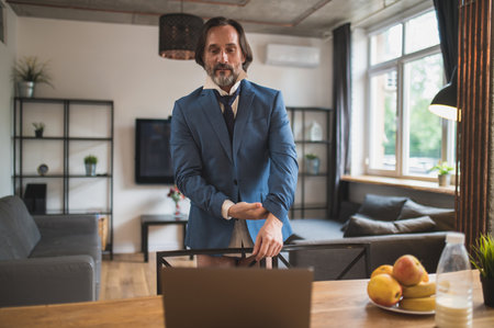 Man sitting in front of the laptop waiting for the video callの写真素材