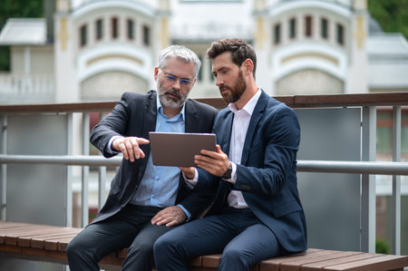 Two businessmen negotioating regarding new property and looking interestedの写真素材