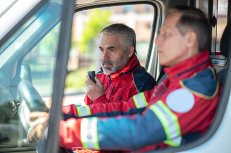 Paramedical personnel riding in the ambulance carの写真素材
