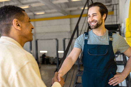 Friendly car workshop worker greeting his clientの写真素材