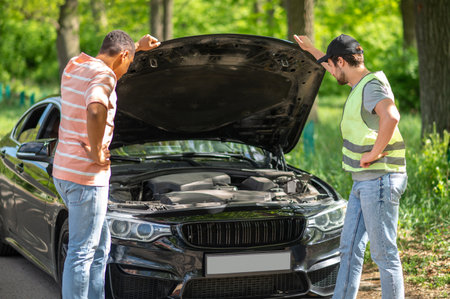 A driver discussing a car accident with a service man and looking uncertain