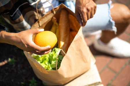Close up of a man with a paper bag with foodの写真素材