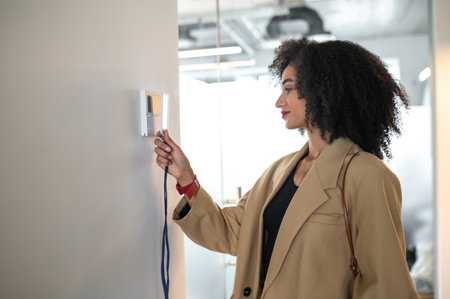 Young manager opening the door with her access cardの写真素材