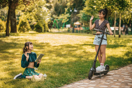 Cute girls spending time in the park and feeling happyの写真素材