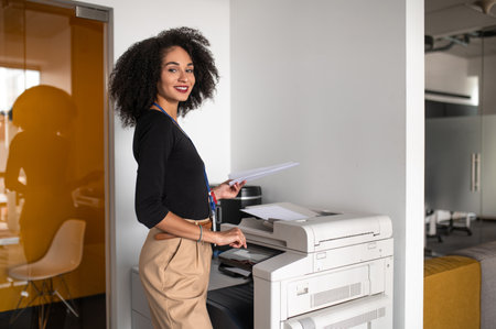 Woman standing near the copy machine in the office