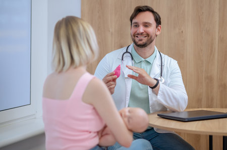 Experienced pediatrician giving a consultation to patientsの写真素材