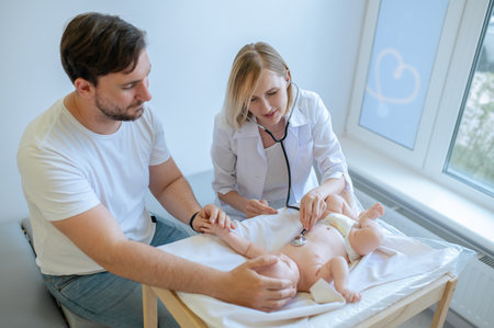 Pediatrician auscultating a baby in her office