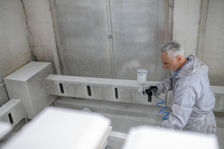 Man in protective clothing working in a carptenter workshop