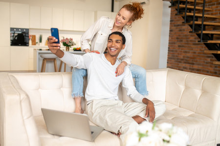 Happy smiling couple making selfie and looking contentedの写真素材