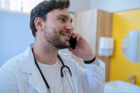Joyful healthcare worker calling on the smartphoneの写真素材