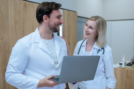 Joyful healthcare workers talking in the reception areaの写真素材