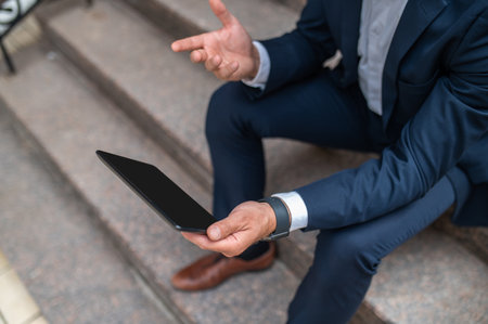 Businessman having a video call outsideの写真素材