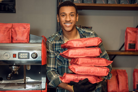 Smiling cafe worker posing for the camera at workの写真素材