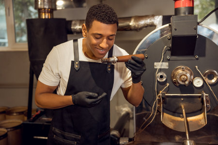 Professional coffee roaster checking the coffee roast degree