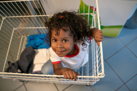 Kid posing for the camera at the laundromatの写真素材