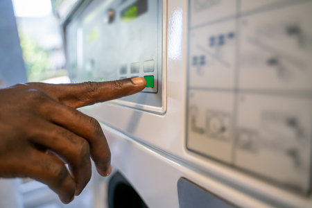 Person choosing the settings on a clothes washerの写真素材