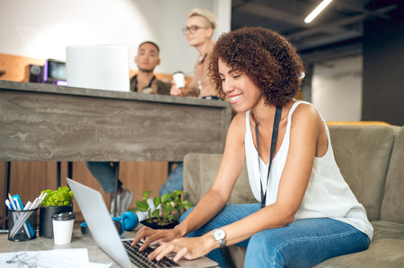 Company employees engaged in work in a modern officeの写真素材