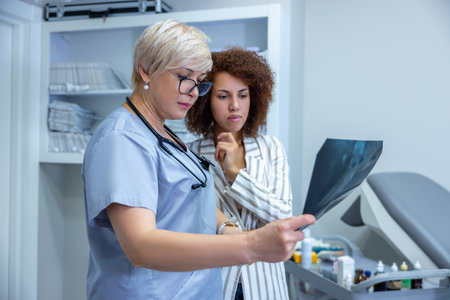 Doctor explaining the xray results to female patient