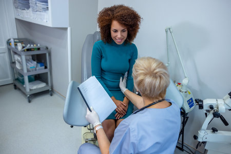Curly-haired woman having an examination at the gynecologist officeの写真素材