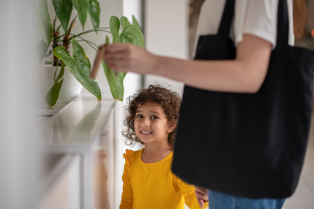 Mom and a little girl in the hotel looking gladの写真素材