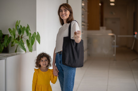 Mom and a little girl in the hotel looking gladの写真素材