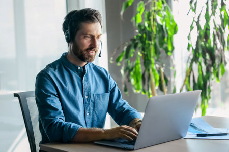 Young man in blue shirt having a business call